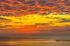 Pier with a dappled sunset