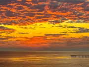 Pier with a dappled sunset